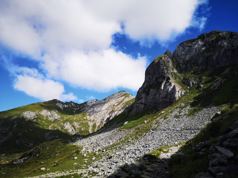 green and gray mountains under blue sky and white clouds during daytime