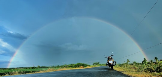 man riding motorcycle on road during daytime in Poondi India
