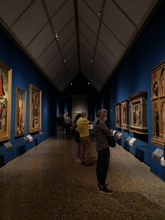 Visitors admiring colorful paintings in a bright gallery space at the North Carolina Museum of Art.