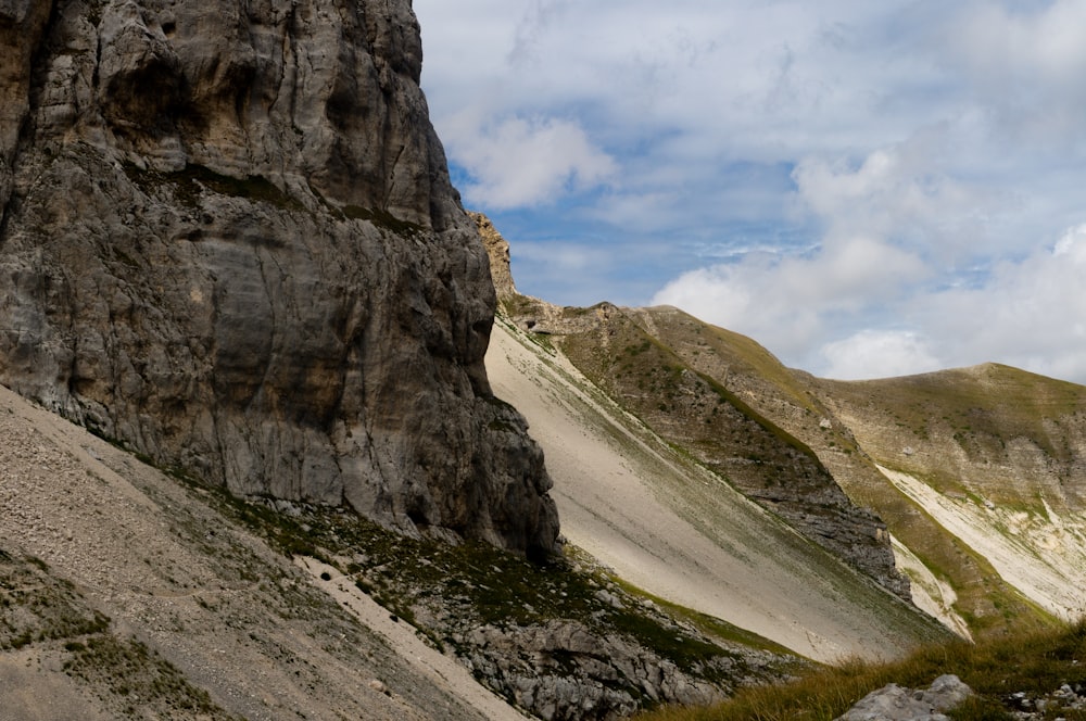 brown rocky mountain under white cloudy sky during daytime