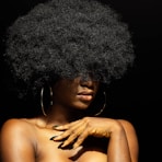 topless woman with black curly hair