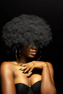 topless woman with black curly hair
