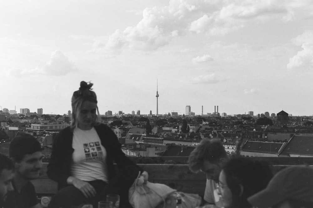 grayscale photo of man in black crew neck t-shirt sitting on bench