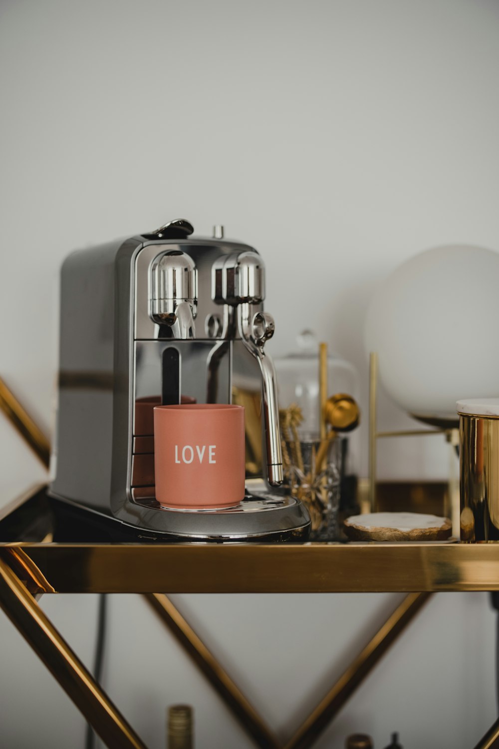 red and silver coffee maker on black table