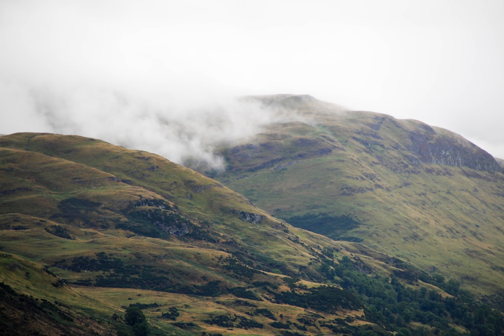 green mountain under white clouds during daytime