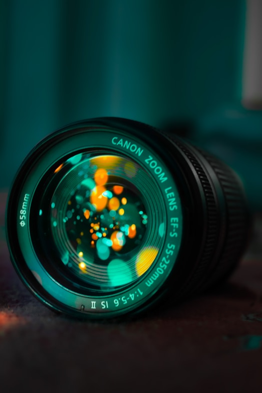 black camera lens on brown wooden table