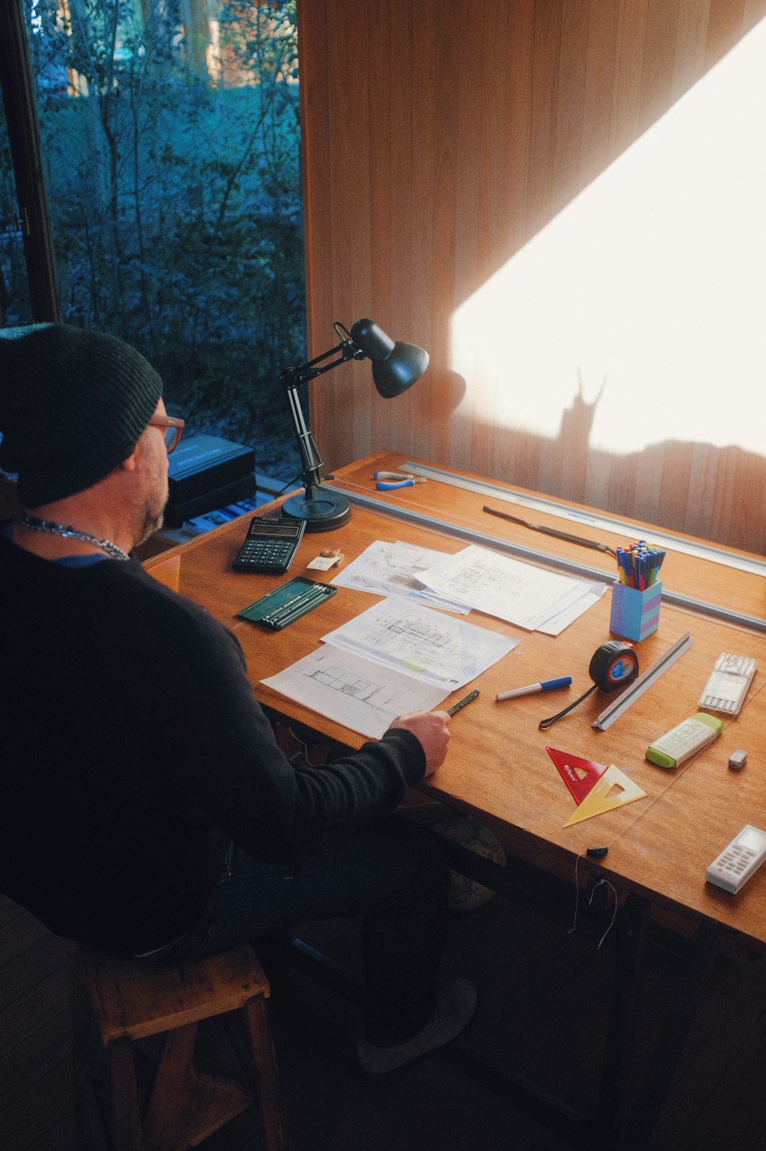 man in black jacket sitting at the table