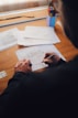 person writing on white paper