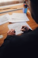 person writing on white paper