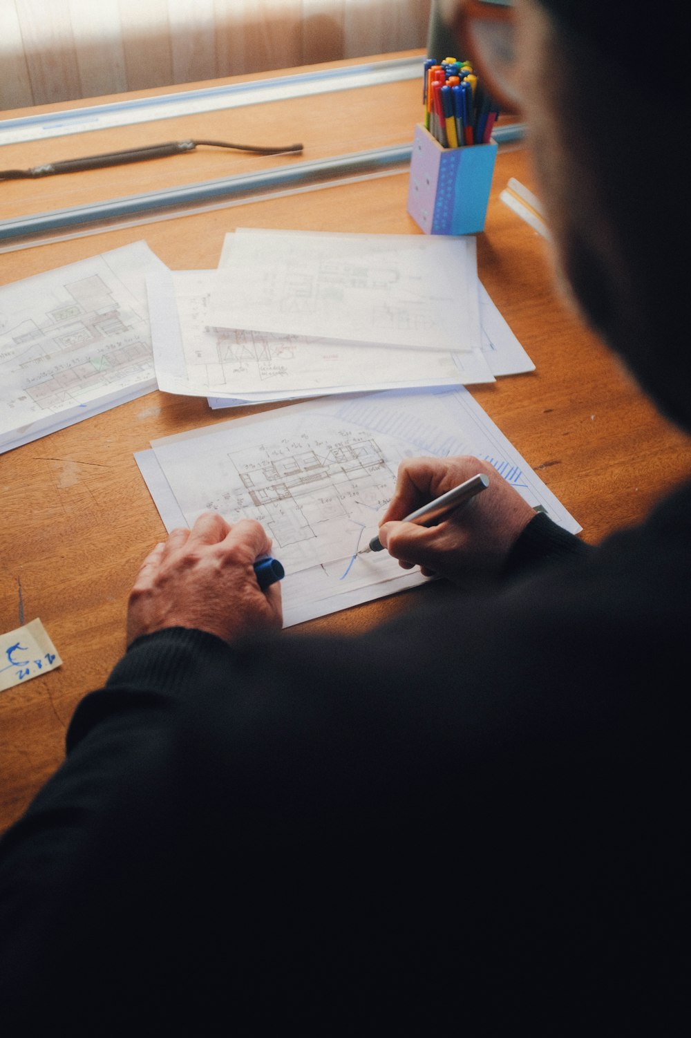 personne écrivant sur du papier blanc