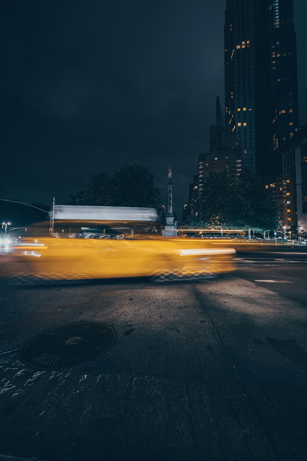 white and yellow taxi on road during night time