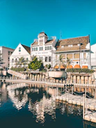 white and brown concrete building beside body of water during daytime
