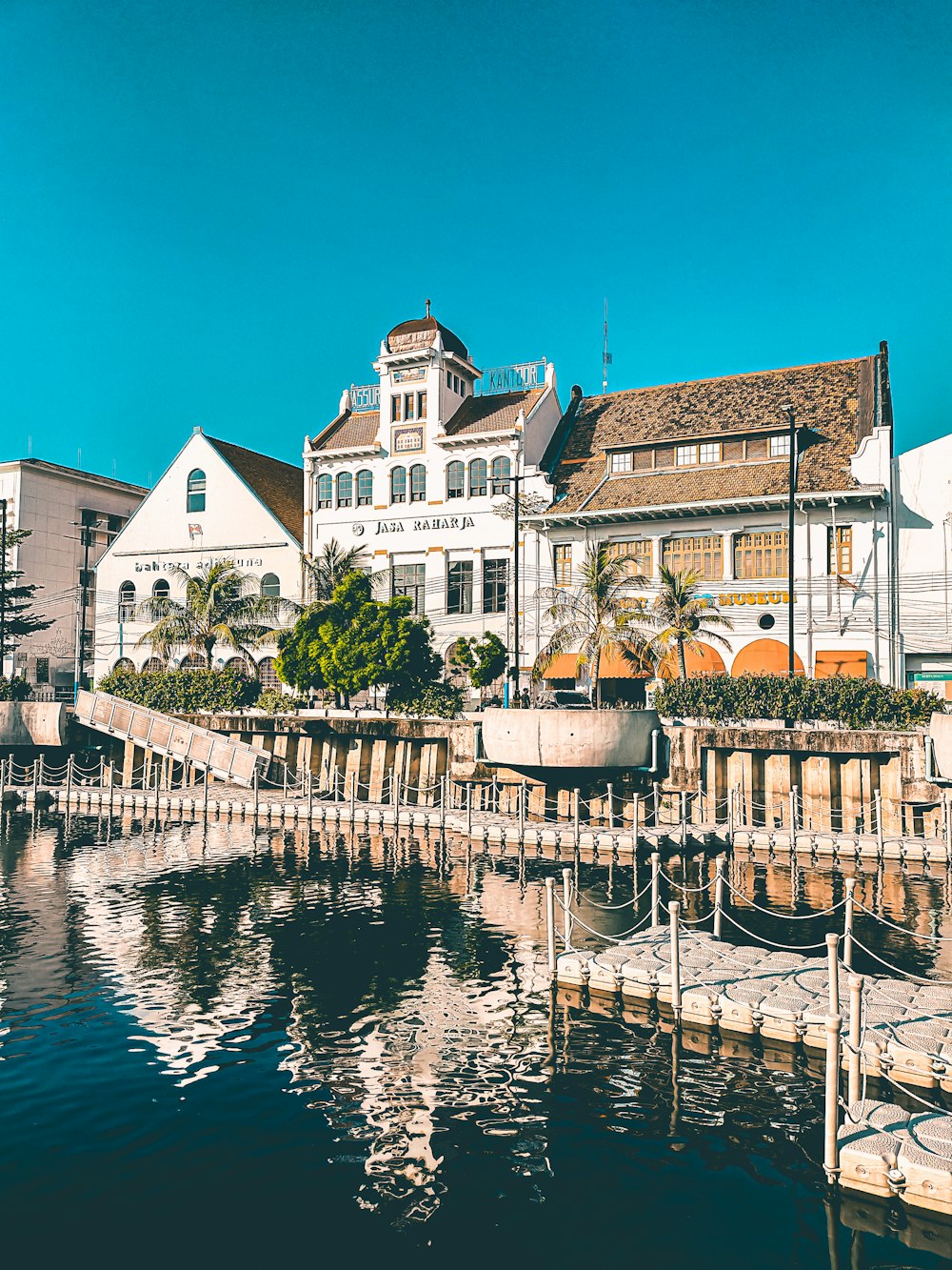 white and brown concrete building beside body of water during daytime