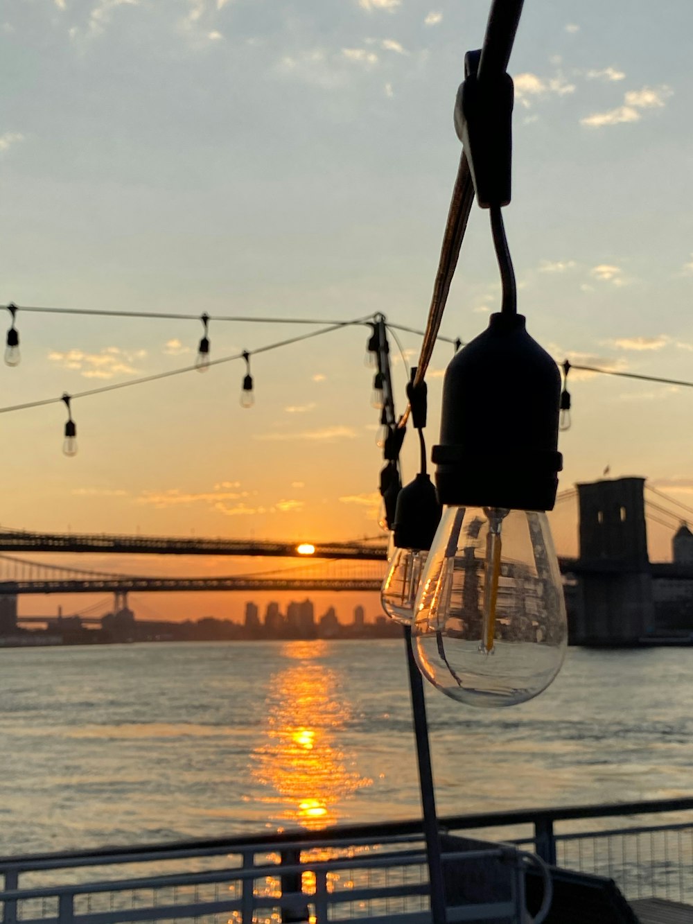 black light post near body of water during sunset