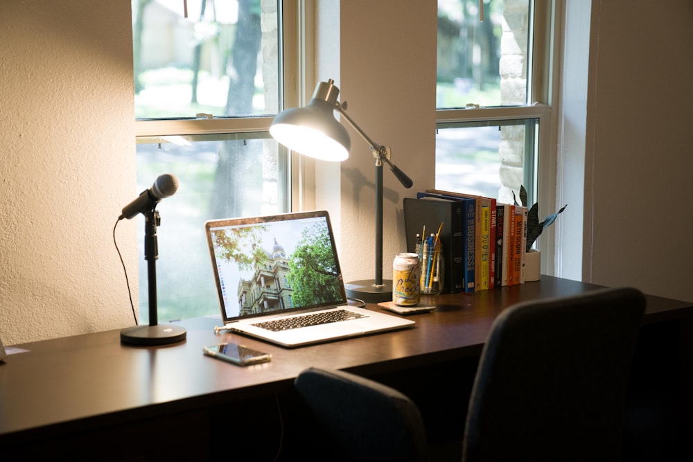 black and silver laptop computer on brown wooden desk