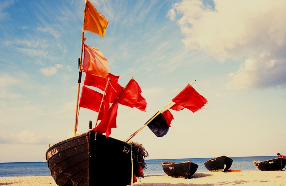 red and white flags on brown wooden boat during daytime