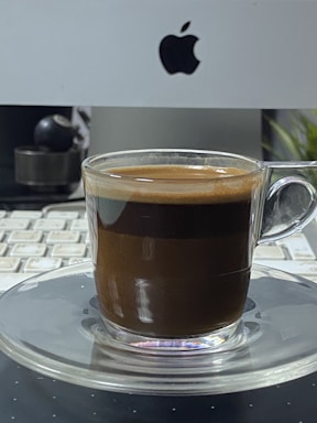Modern office workspace with computer and coffee cup on desk.