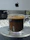 A satisfied customer checking out their order confirmation on a laptop with a cup of coffee nearby.