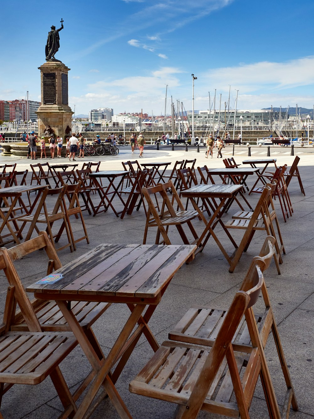 brown wooden folding chairs on gray concrete floor during daytime