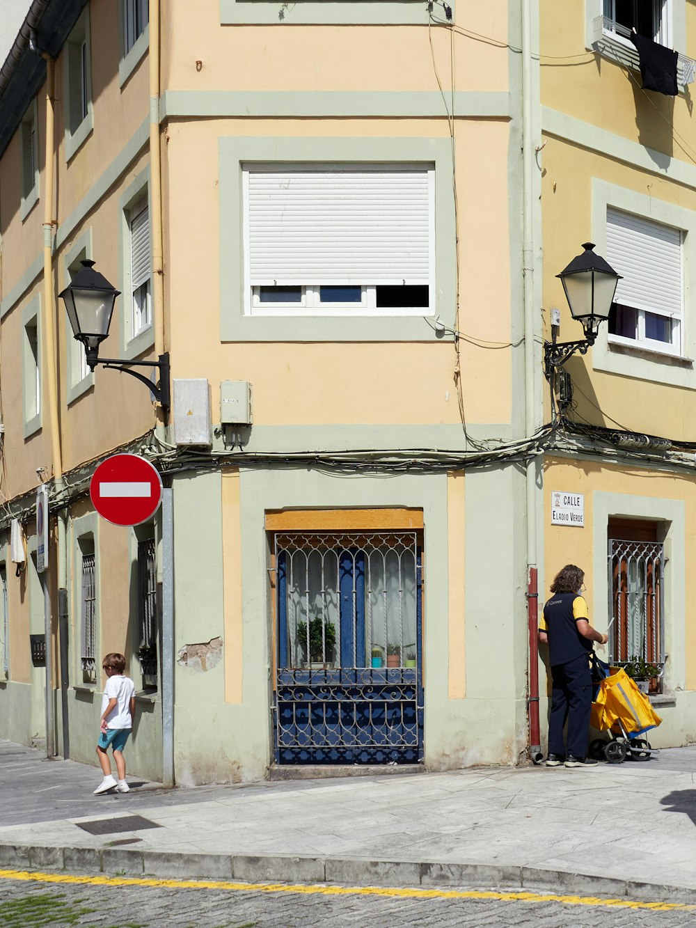 people walking on sidewalk near building during daytime