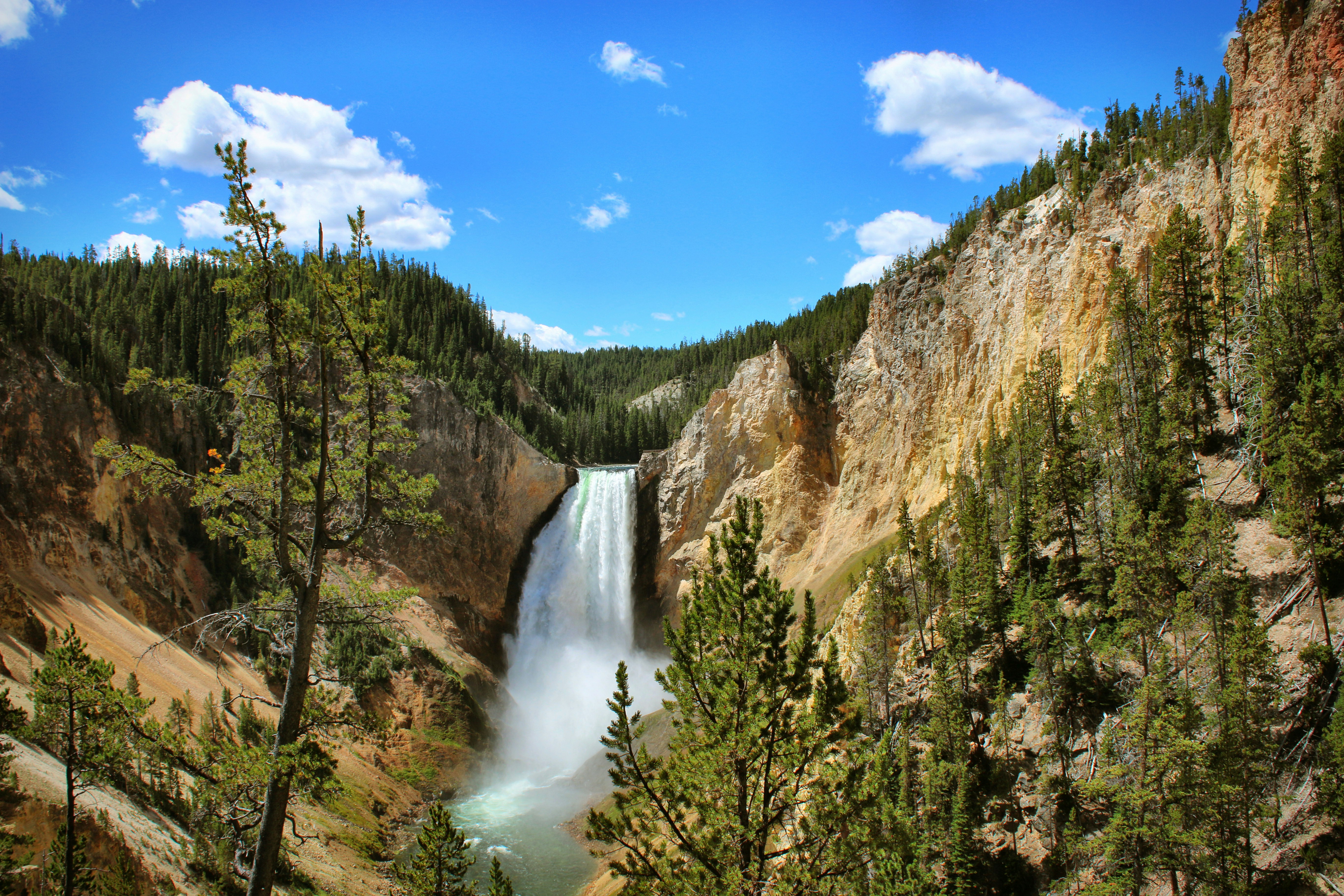 waterfalls under blue sky during daytime