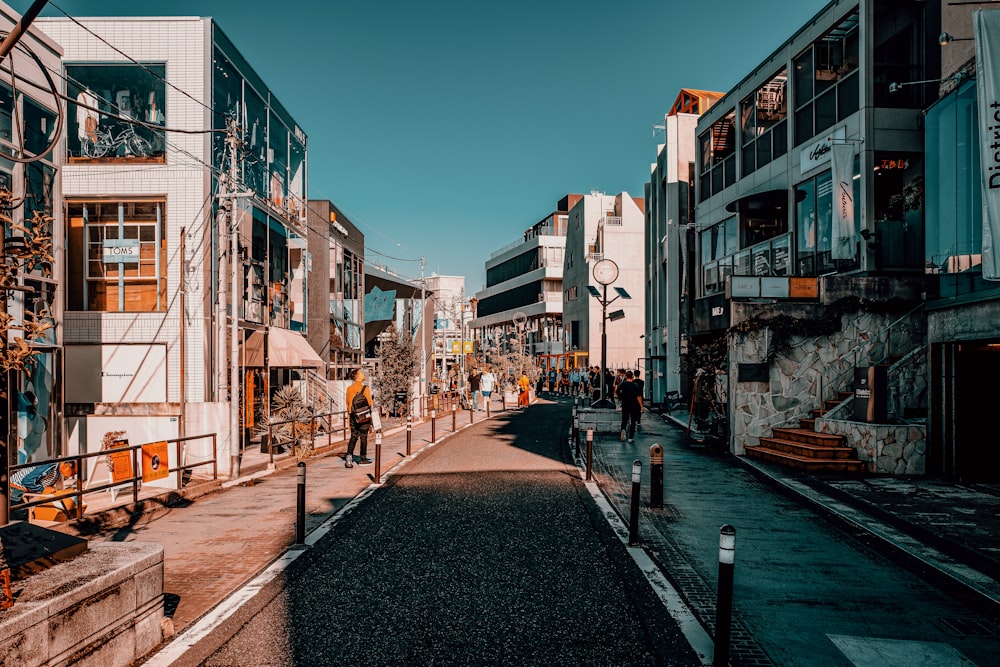 people walking on sidewalk near buildings during daytime