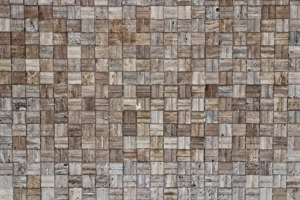 Close-up of textured stone tiles stacked neatly, showcasing colors and patterns for interior design.