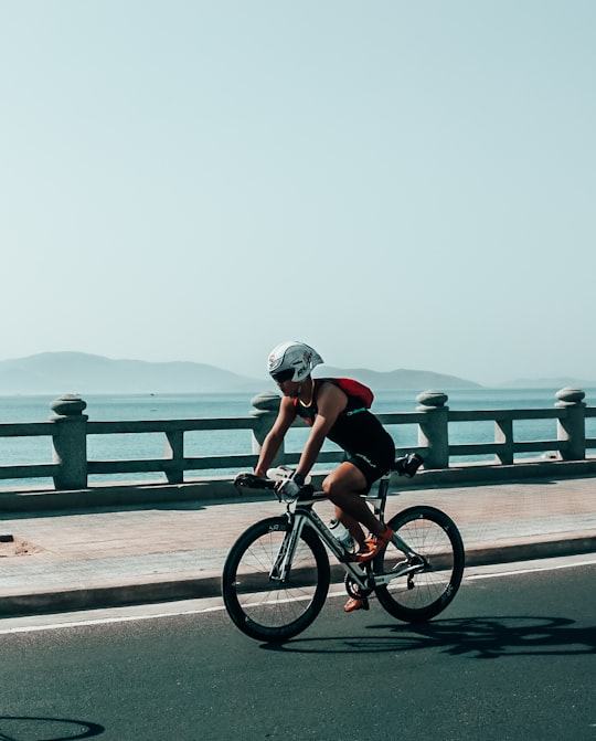 man in black shirt riding bicycle on road during daytime in Nha Trang Vietnam