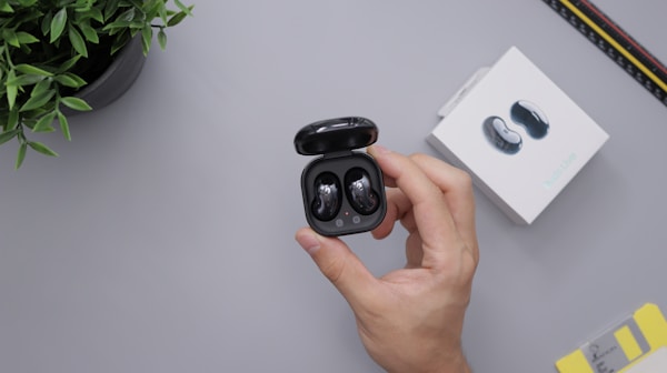person holding black round plastic