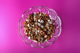 brown and white beans in clear glass bowl