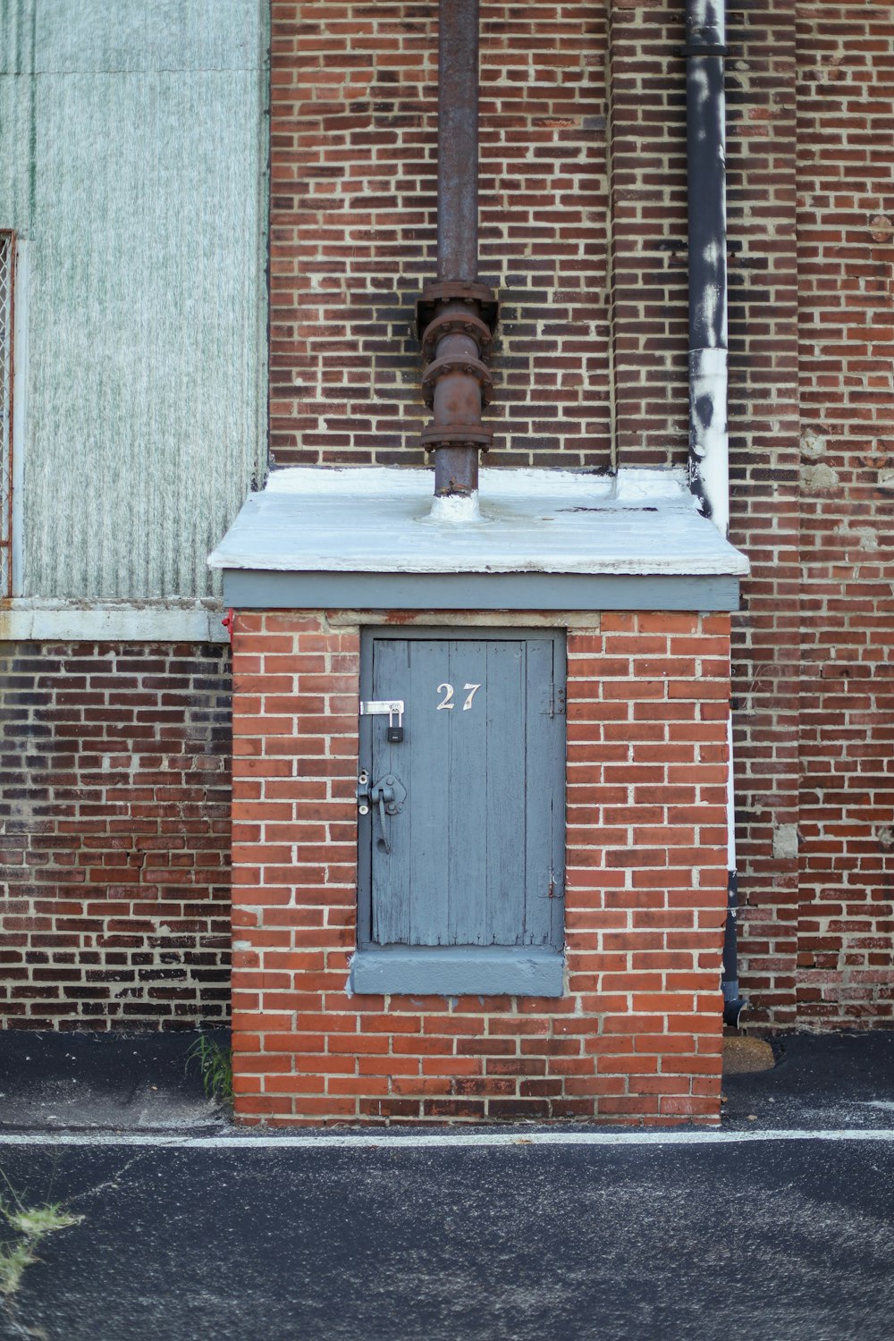 brown brick wall with black wooden door