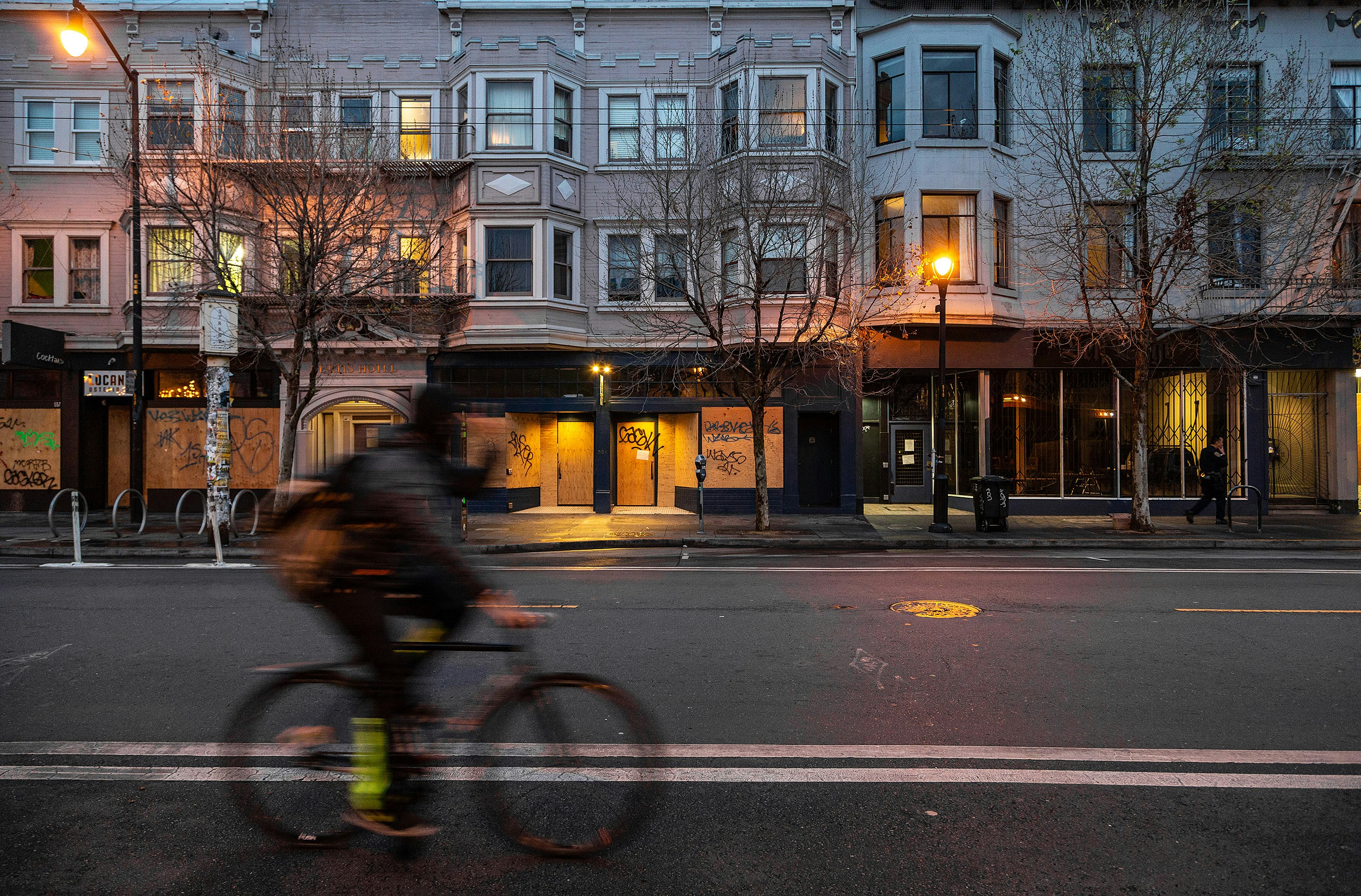 man in black jacket riding bicycle on road during daytime