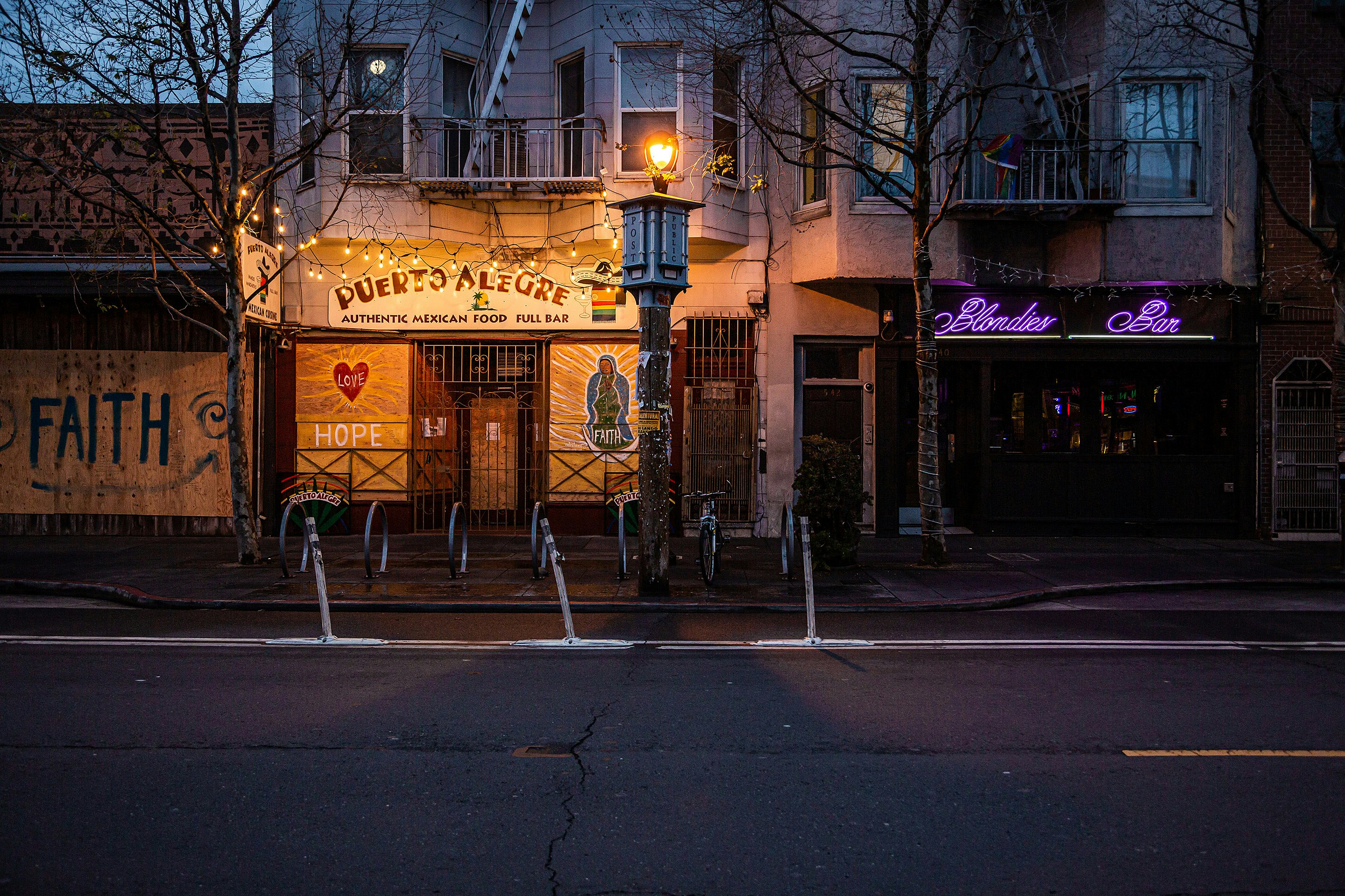 bare trees in front of yellow building