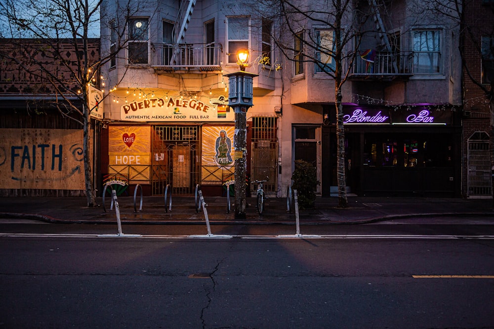 bare trees in front of yellow building