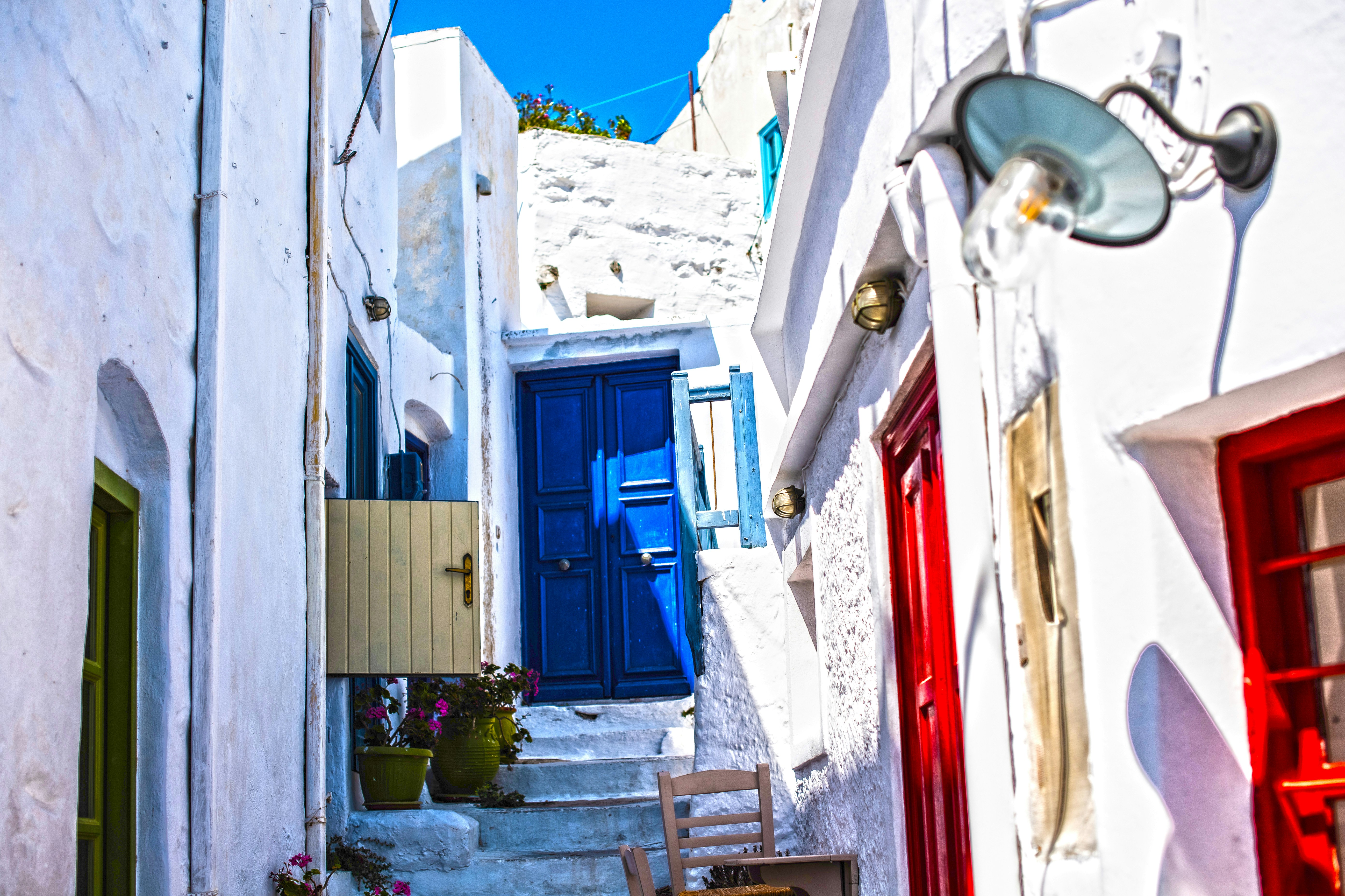 blue wooden door on white concrete building during daytime