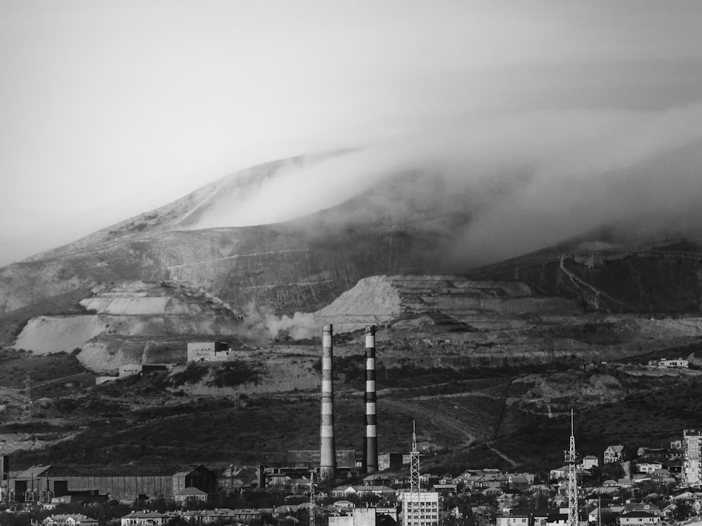 grayscale photo of city near mountain