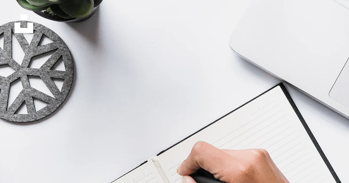 Person writing on white notebook photo – Free Hands Image on Unsplash