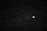 A serene night sky filled with twinkling stars and a glowing crescent moon.