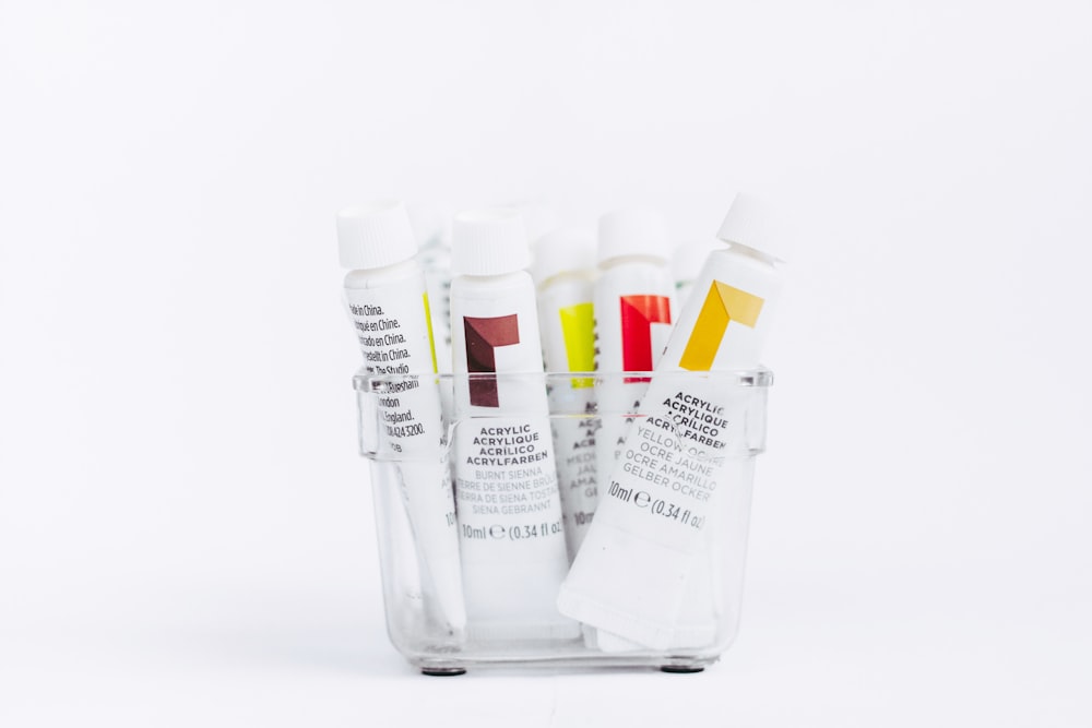 white and yellow plastic tube bottles