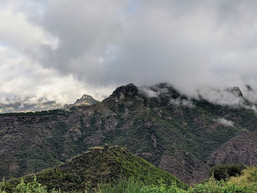 green mountain under white clouds during daytime