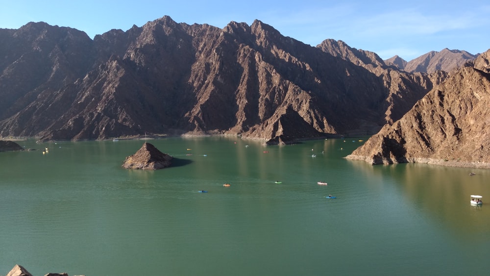 brown rock formation on green water