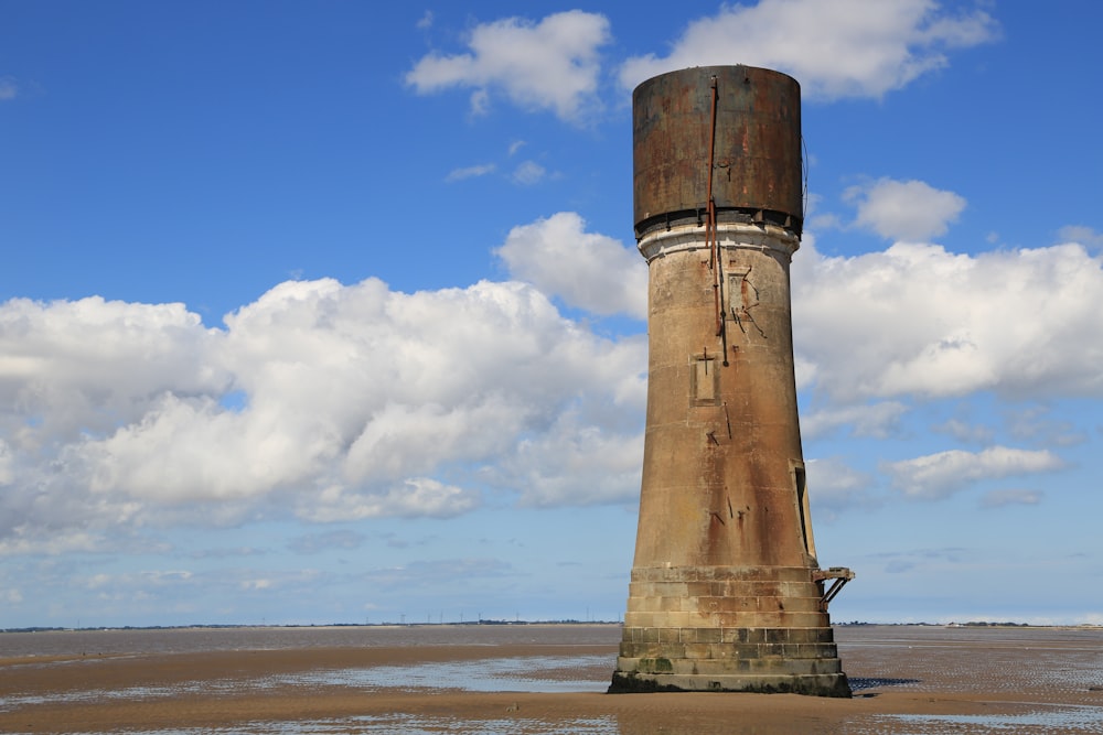 brown concrete post on beach during daytime