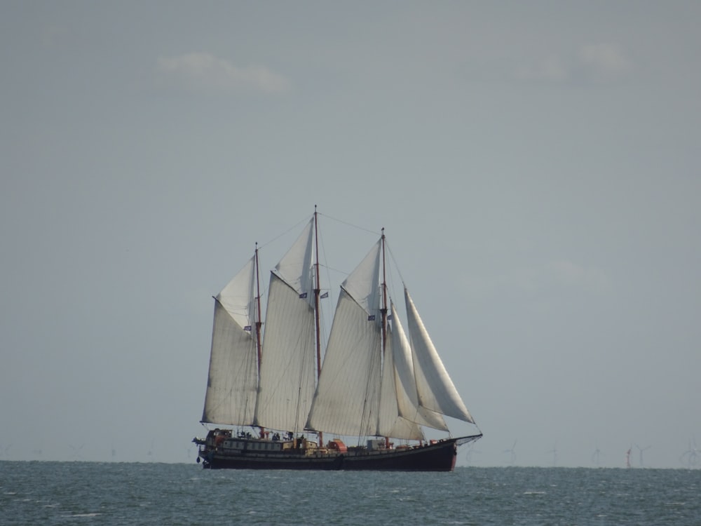 white sail boat on sea during daytime