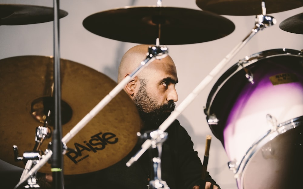 man in black jacket playing drum