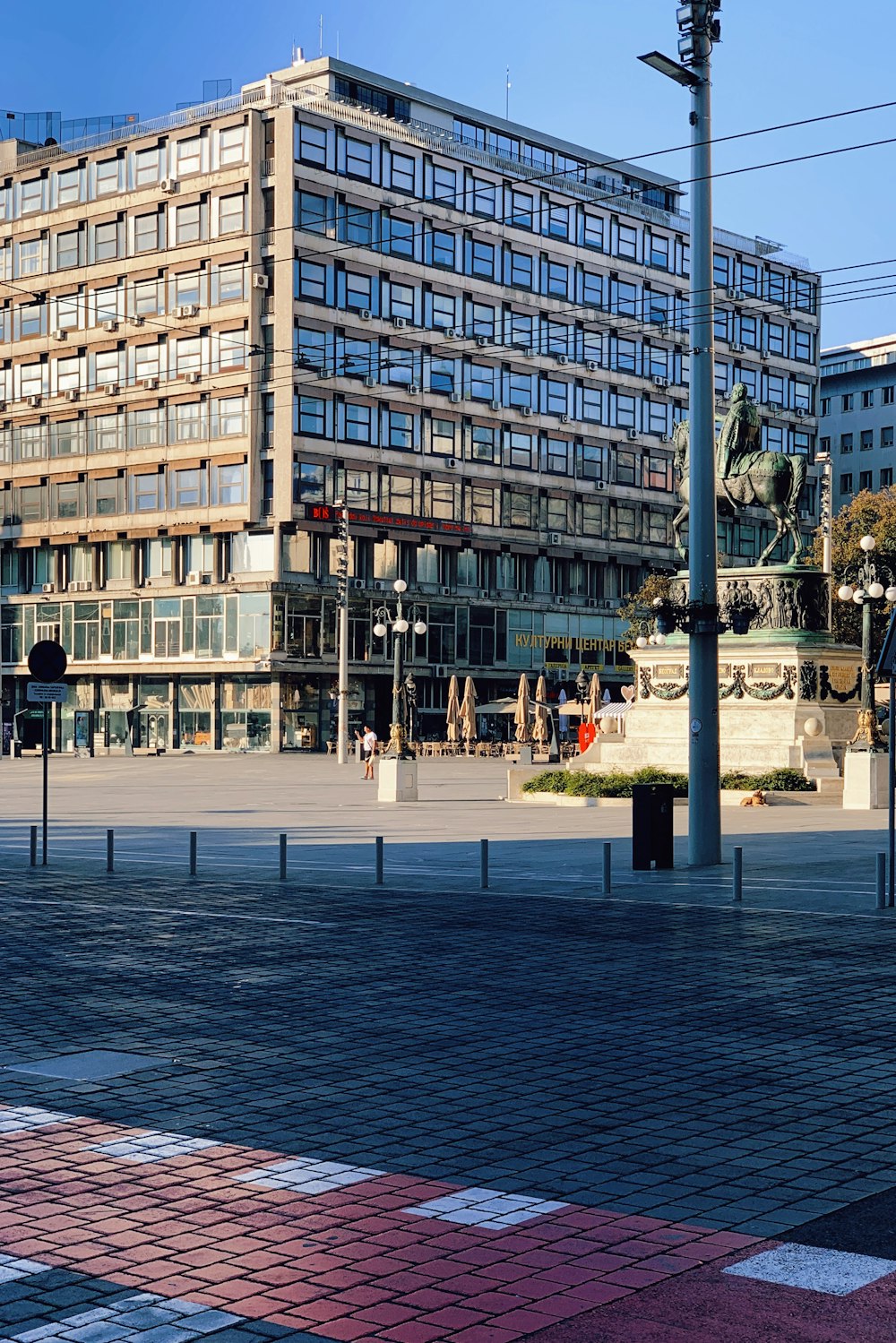 les gens qui marchent sur le trottoir près de l’immeuble pendant la journée