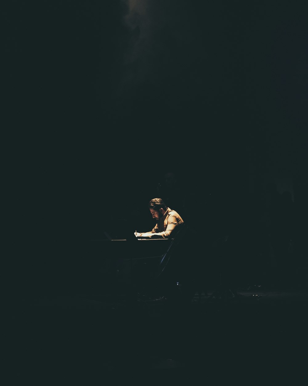 woman in black dress sitting on black floor