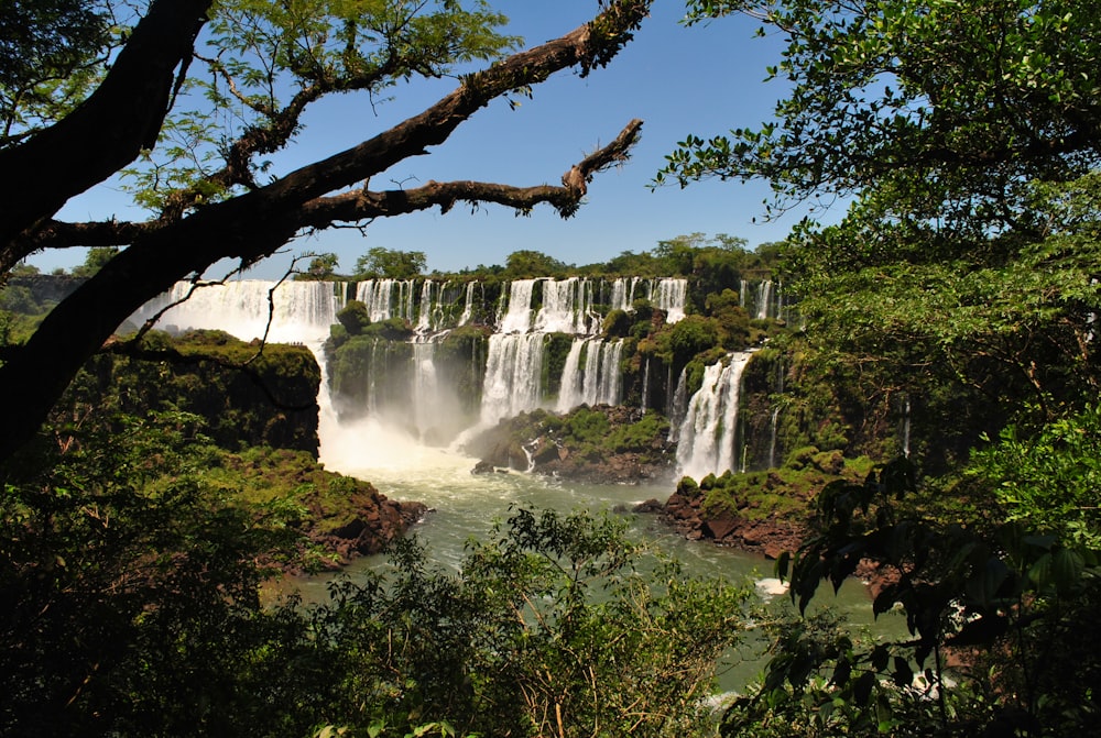 waterfalls under blue sky during daytime