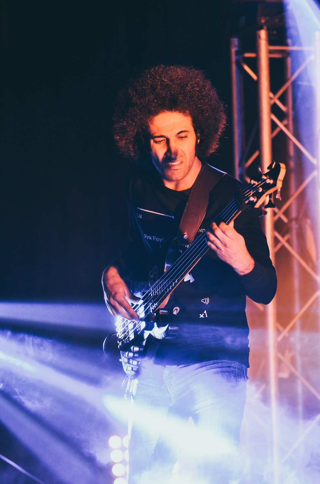 man in black button up shirt playing guitar