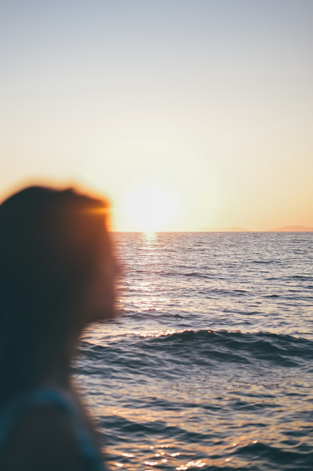 person in body of water during sunset