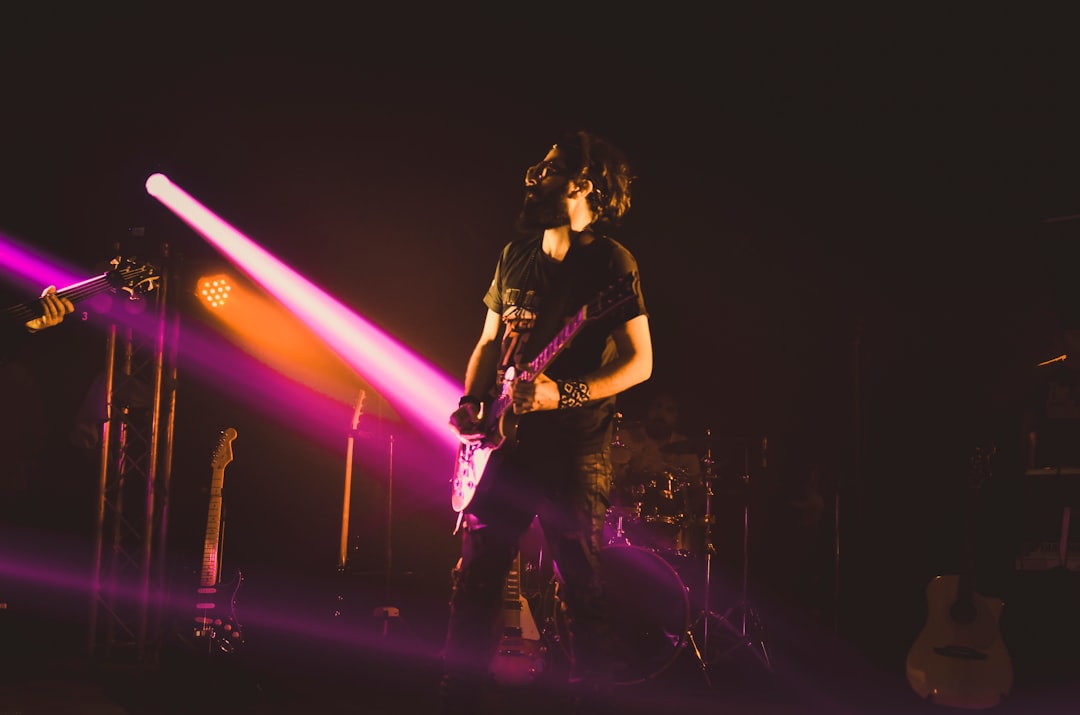 woman in black shirt singing on stage